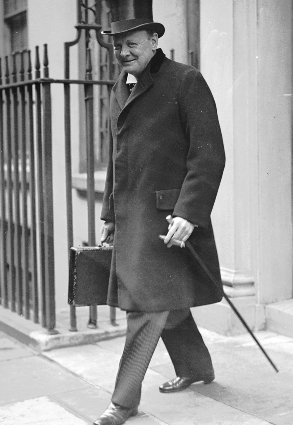 28th April 1925:  Chancellor of the Exchequer Winston Churchill (1874 - 1965) leaves 11 Downing Street, London, on his way to present the budget.  (Photo by Kirby/Topical Press Agency/Getty Images)